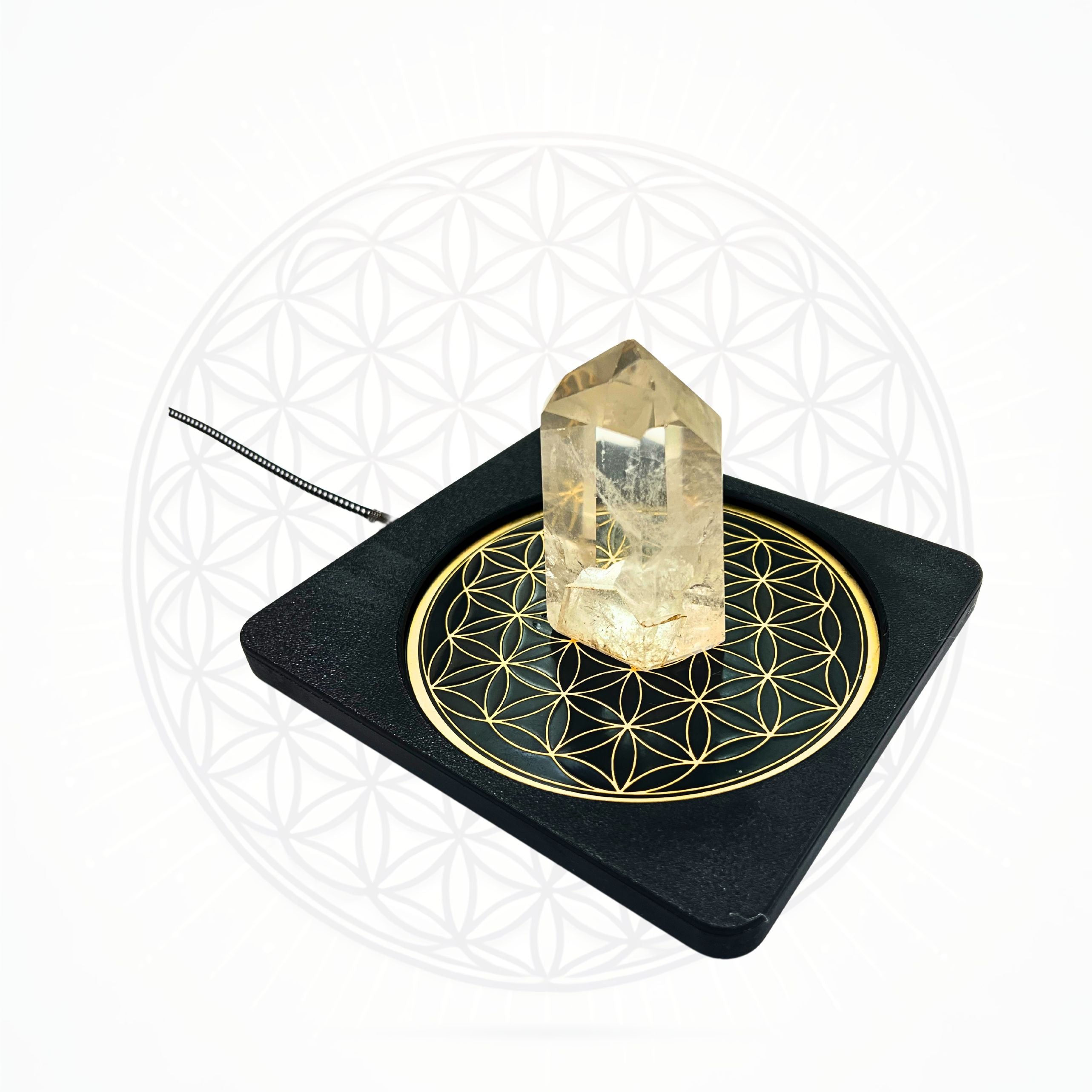 Metatronic Flower of Life Frequency Imprinter with clear quartz crystal on black base by Sacred Ritual Oils