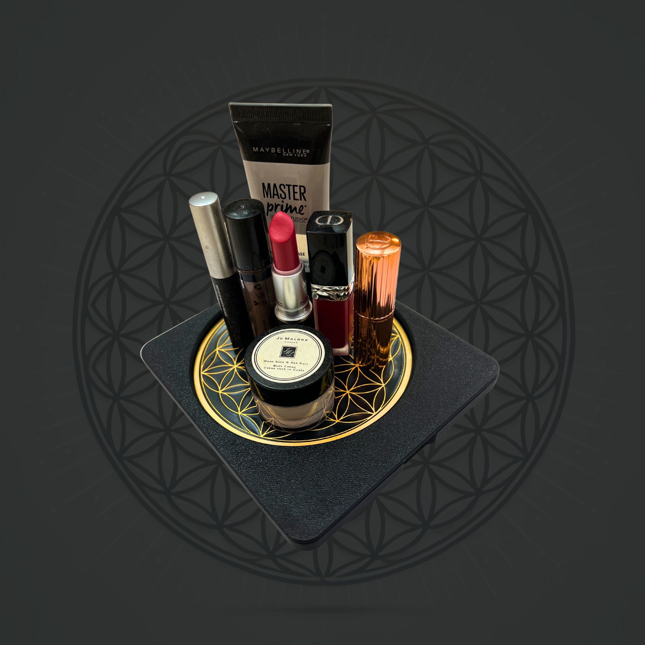 Sacred Ritual Oils Metatronic Flower of Life Frequency Imprinter holding makeup items on black base