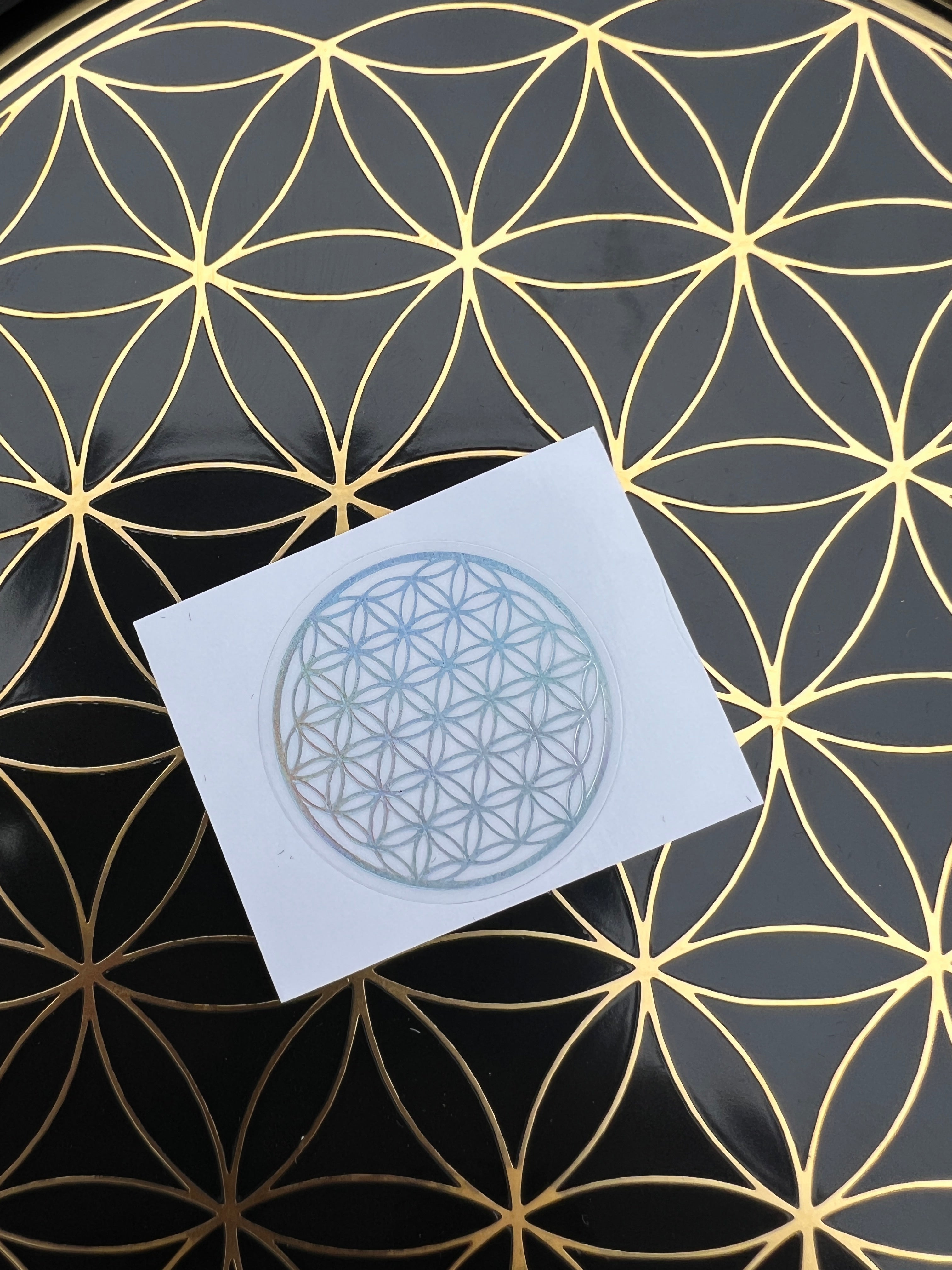 Sacred Ritual Oils Sacred Flower of Life patches with a geometric flower design on a gold and black patterned background